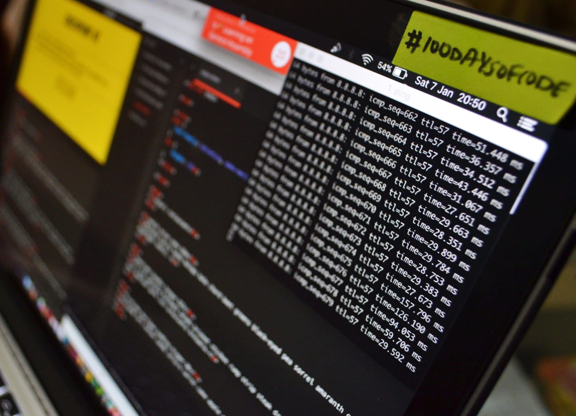 Laptop screen showing terminal logs and notes