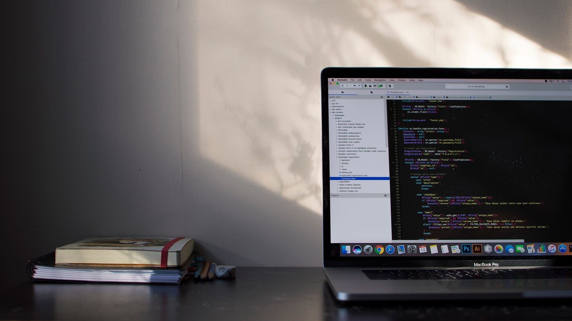Laptop on a dark desk showing code in an editor